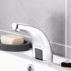 A closeup of a shiny modern faucet soap and toothbrushes Closeup of a shiny modern faucet soap and toothbrushes